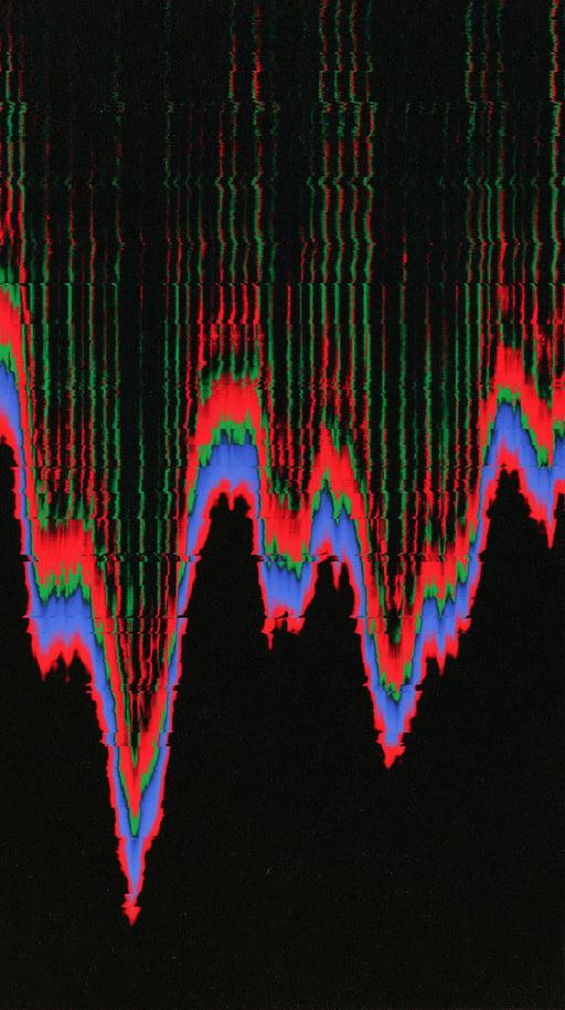 Abstract glitch art waveform with red, green, and blue chromatic aberration lines cascading down a black background.