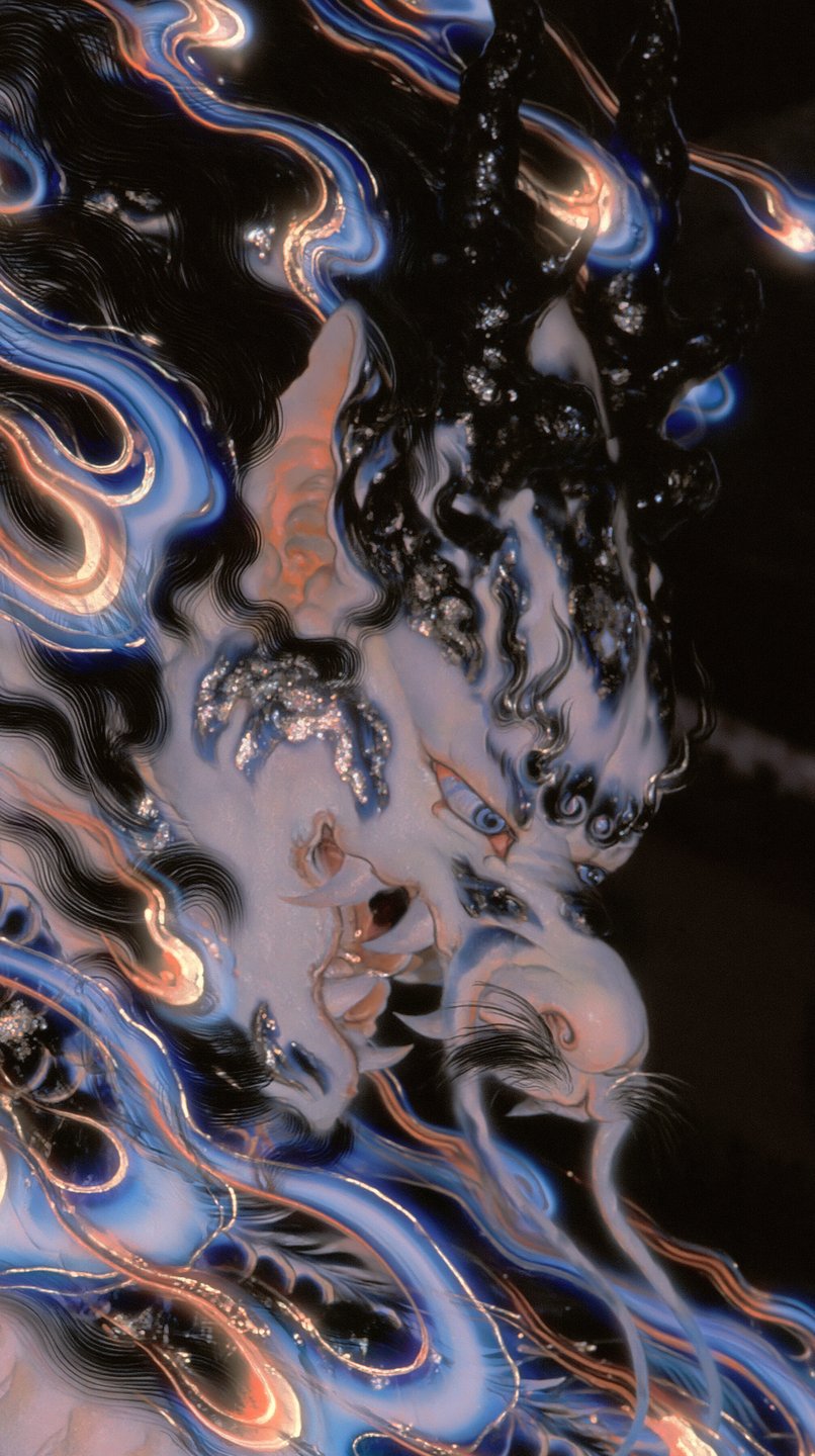 Stylized profile of a fierce Japanese dragon surrounded by swirling blue and gold liquid flames.