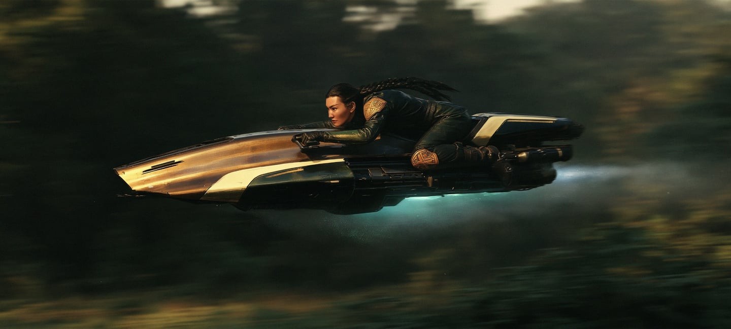 Female pilot leaning forward on a streamlined hoverbike racing swiftly past blurred green forest foliage.