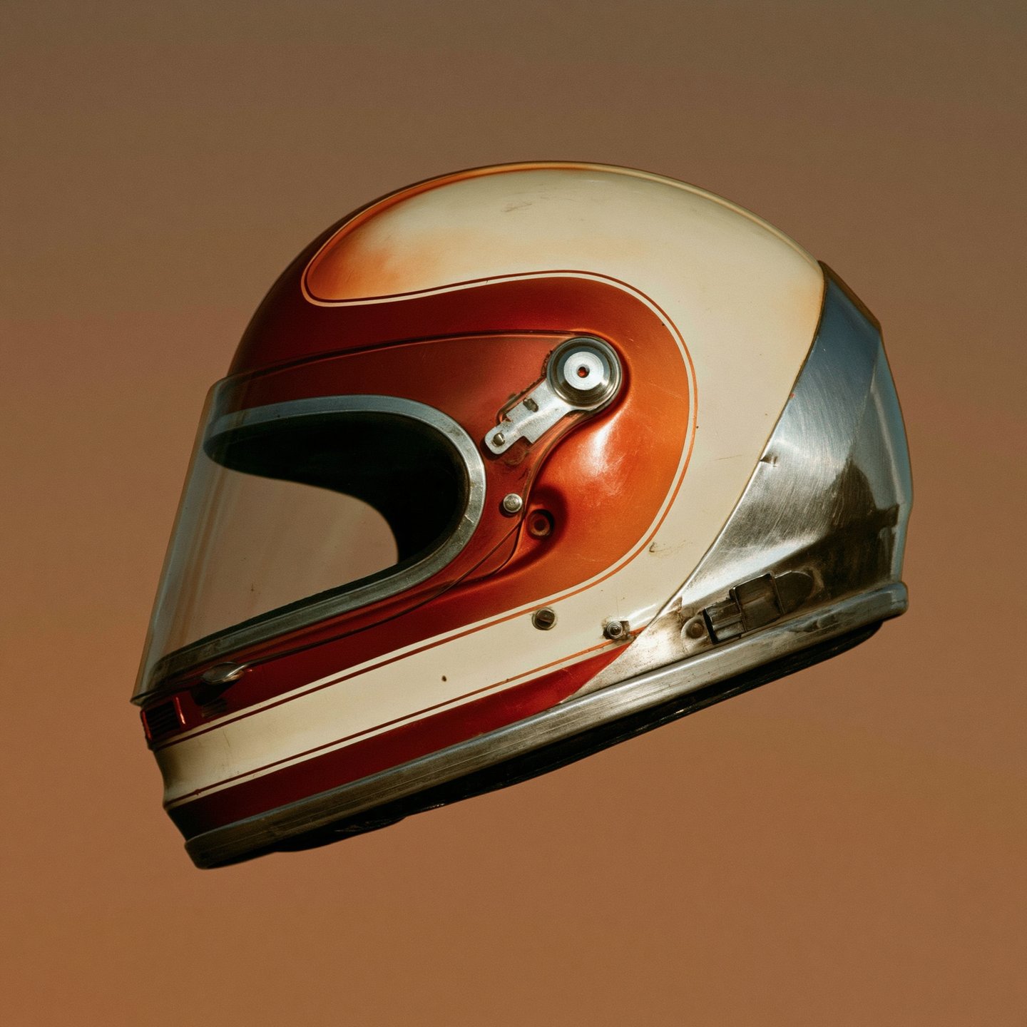Vintage burnt orange and cream motorcycle helmet floating in profile against a solid terracotta background.