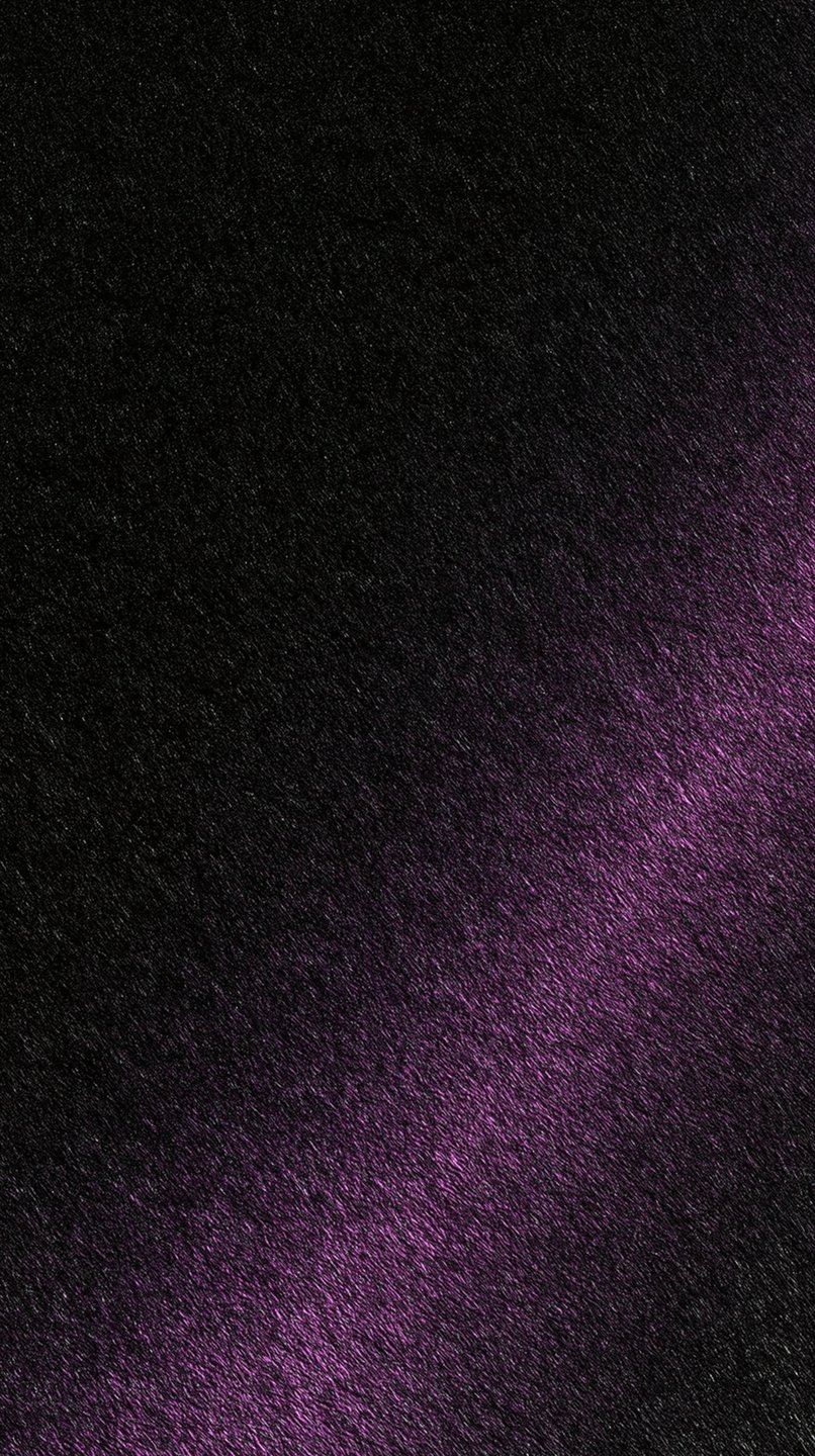 A dark textured black surface bisected diagonally by a soft, glowing beam of violet light.