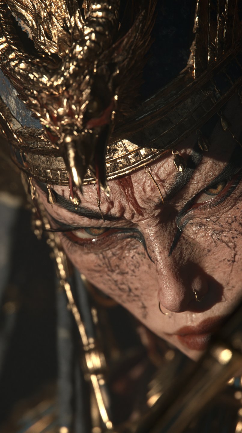 Close-up of a battle-worn female warrior wearing an ornate golden crown with an intense downward gaze.