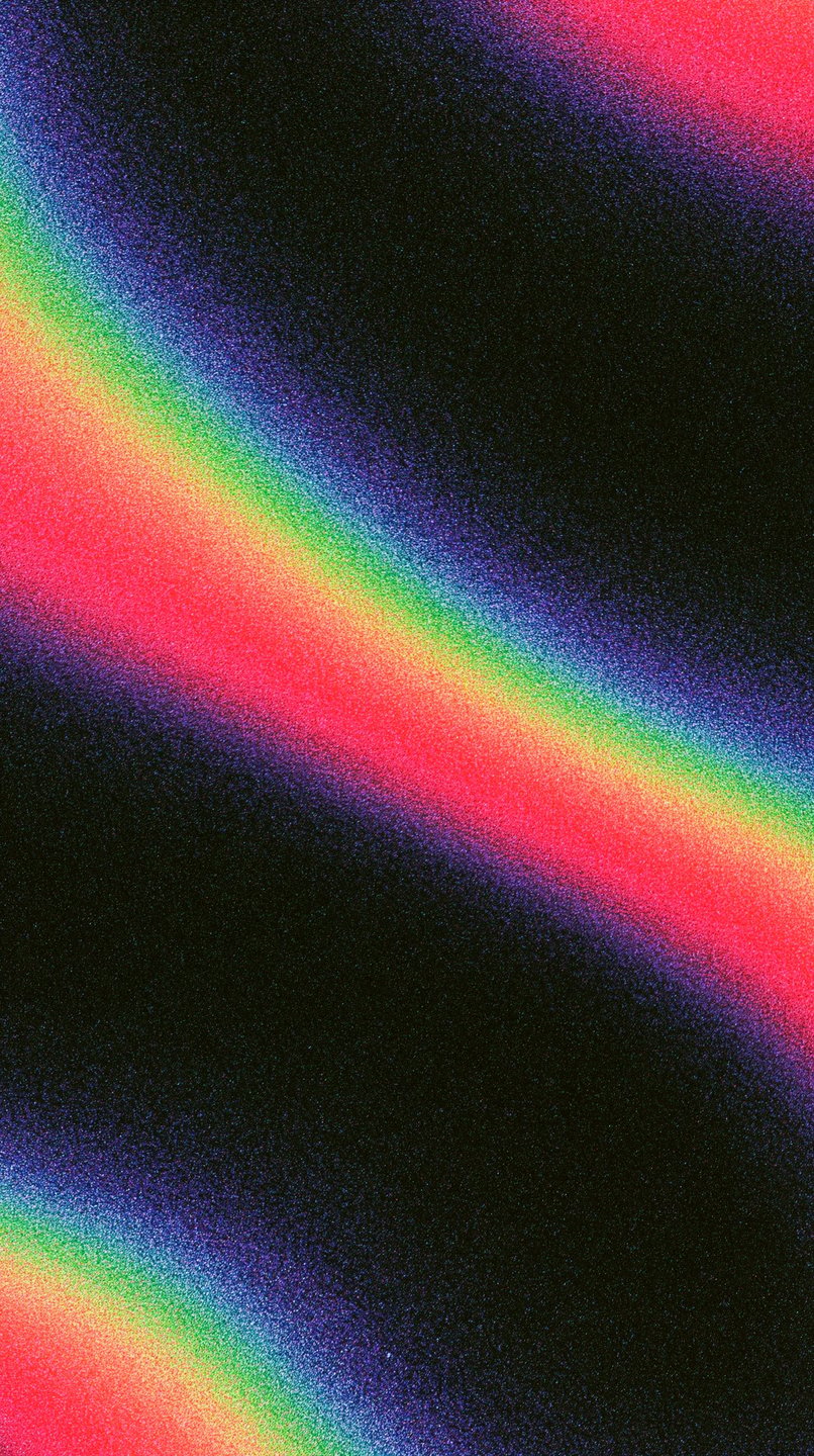 Vibrant diagonal rainbow spectrum light leak with heavy film grain texture on a dark black background.