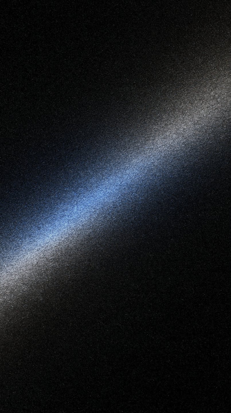 A diagonal beam of blue and white light shines across a dark, heavily textured metallic surface.