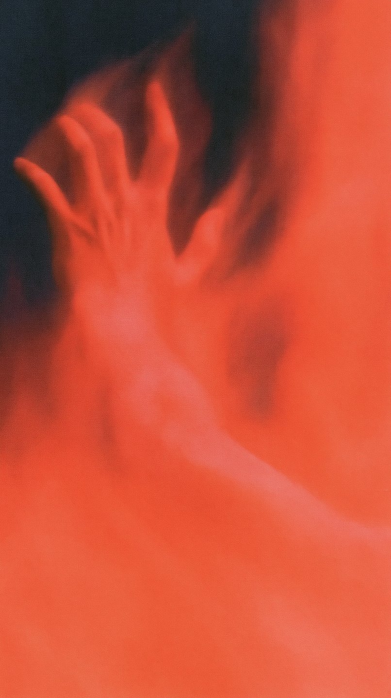 A pale hand reaches upward, heavily obscured by a dense, glowing red mist against a dark background.