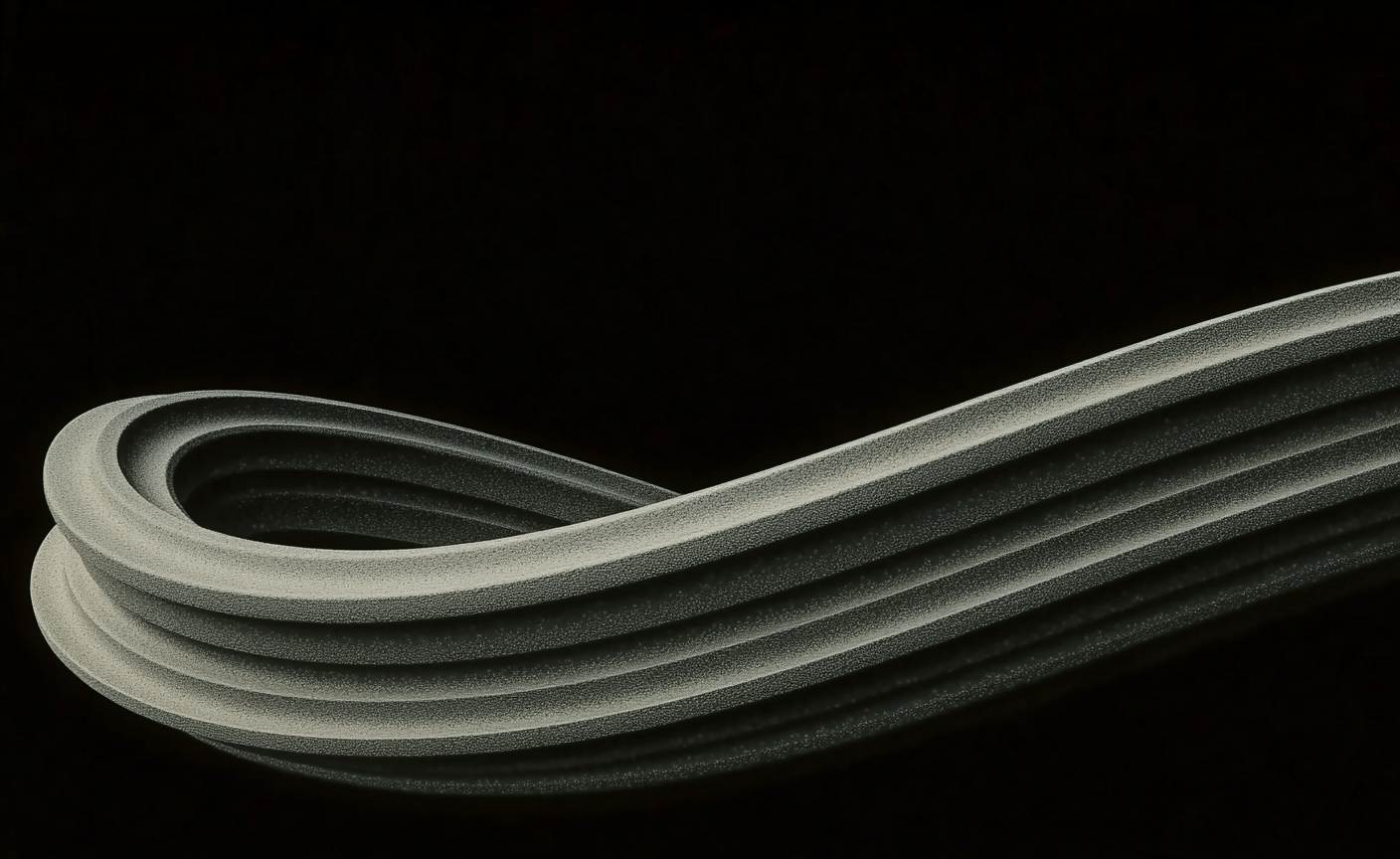 Textured grey ribbed sculptural loop curves gracefully against a deep black background with soft specular highlights.