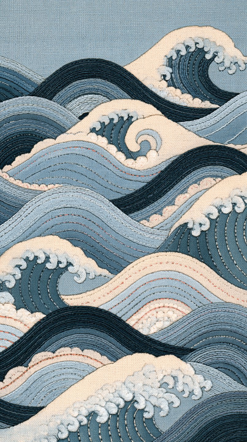 Intricate embroidery depicting stylized Japanese-style ocean waves in shades of blue and cream on linen fabric.