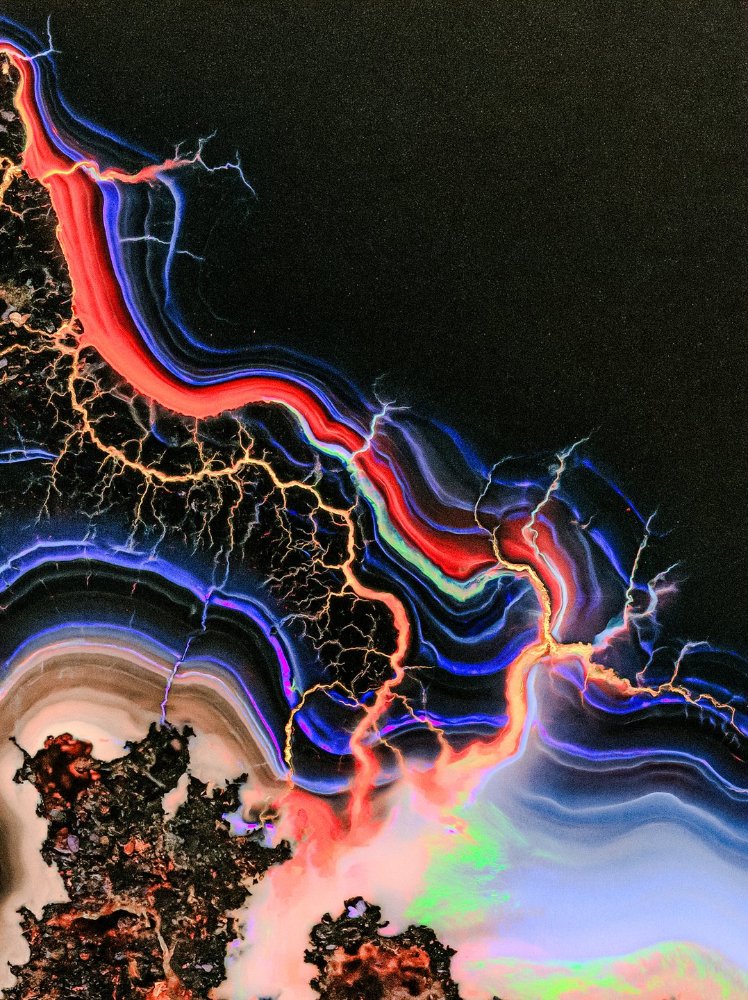 Vivid red and blue plasma arcs branch across dark obsidian with iridescent mineral banding.