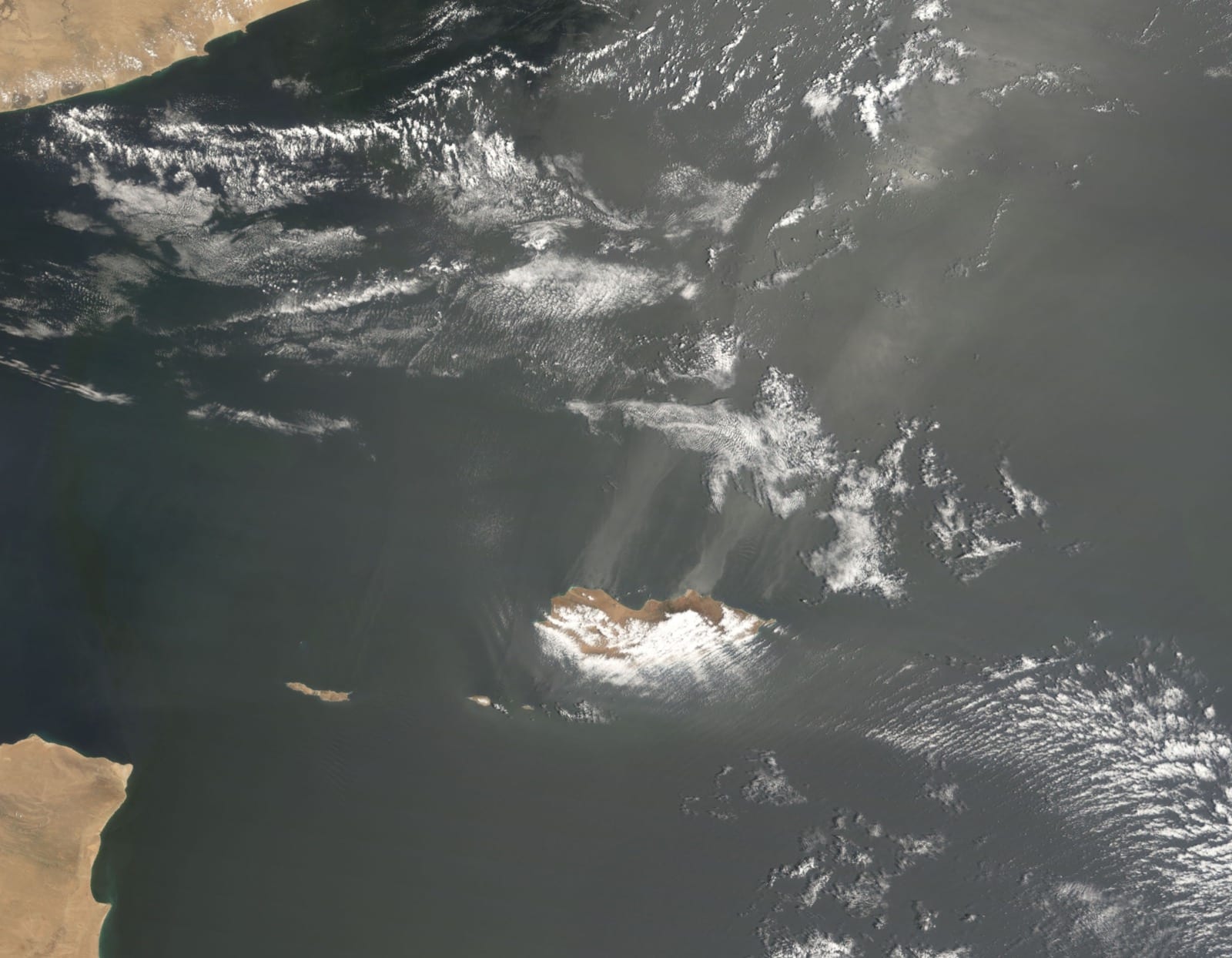 Socotra in the Arabian Sea with faint streaks of dust downwind of it