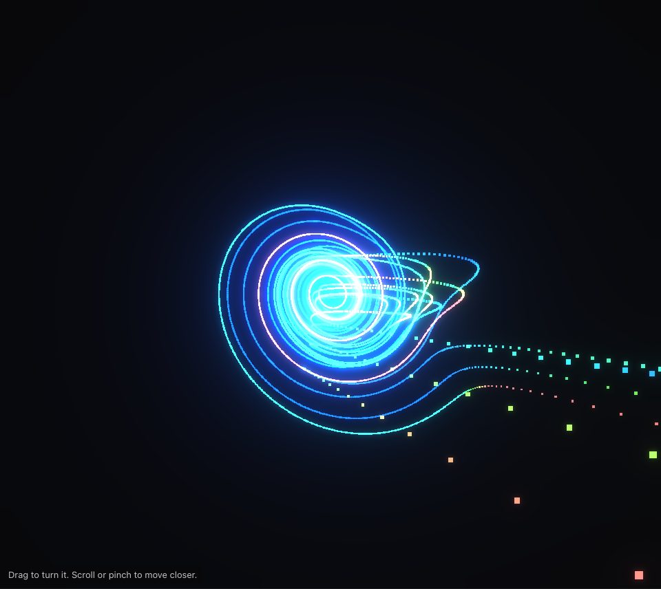 Rings of cyan and blue dots circling a bright white centre, with a few strands streaming off to the lower right and scattered green, blue and orange squares drifting away, on a dark ground